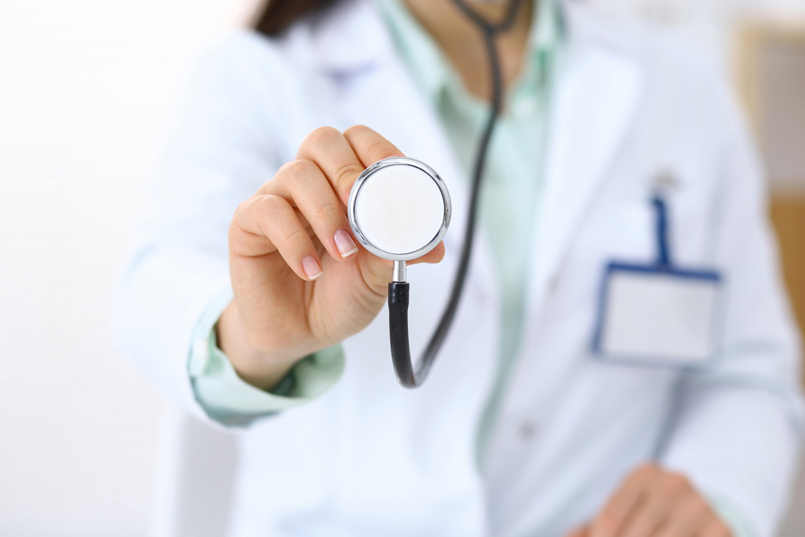 Doctor holds stethoscope head, closeup. Medical help and insurance in health care, best treatment and medicine concept